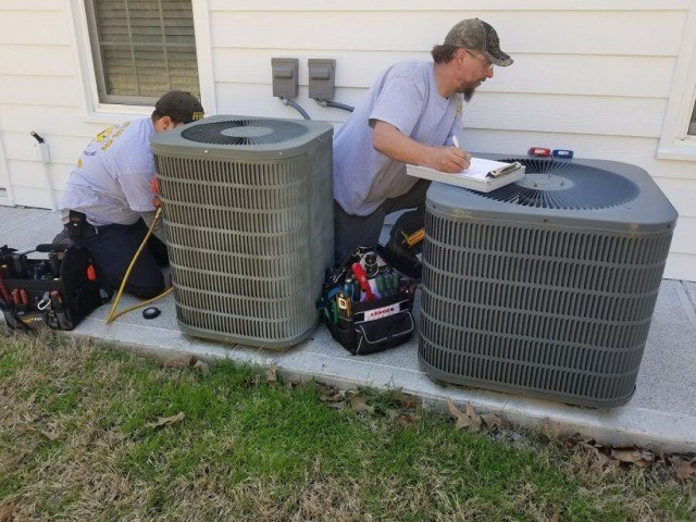 Technicians Repair AC Unit